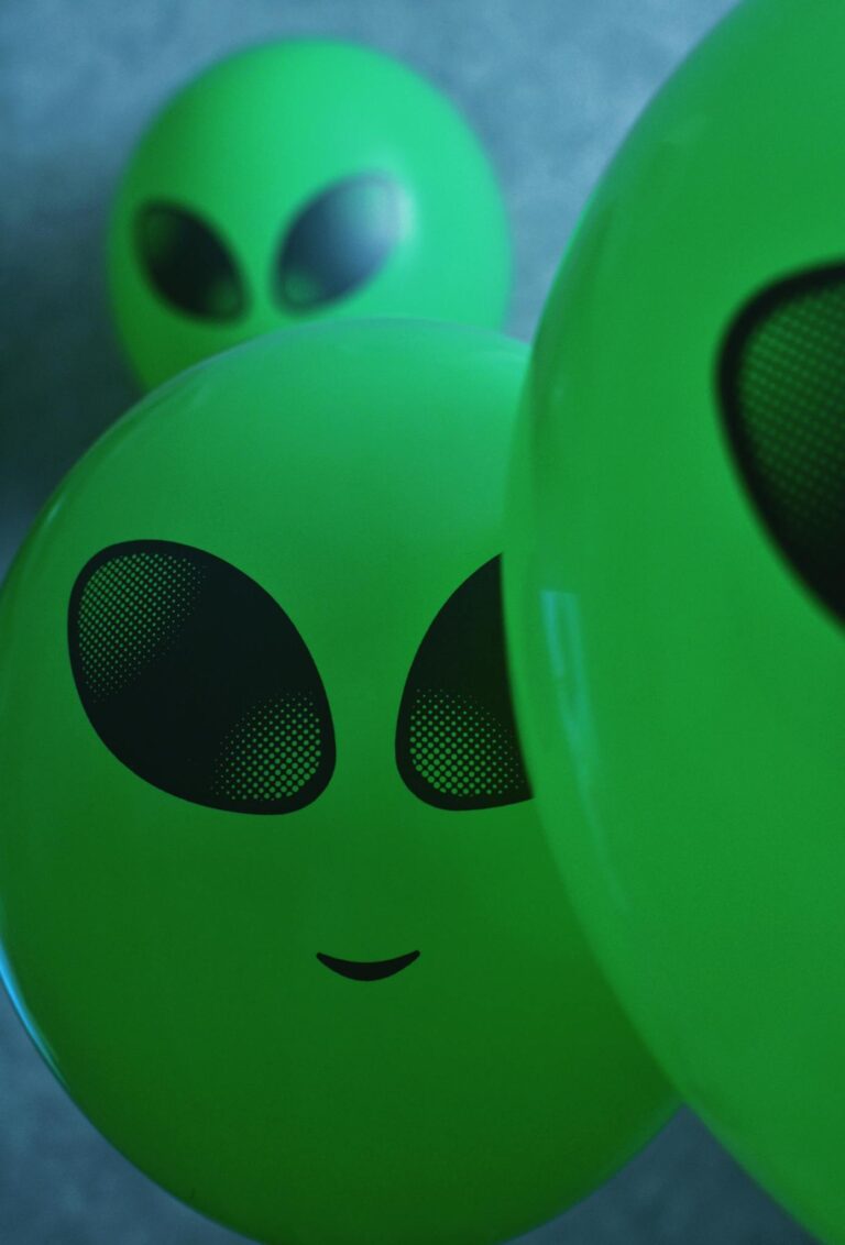 Close-up of green alien-themed balloons creating a playful and imaginative atmosphere.